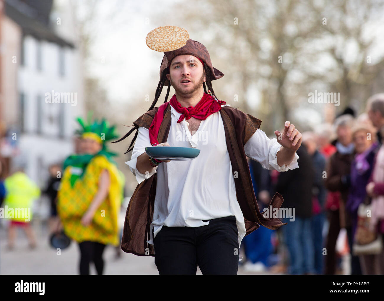 L annuale Martedì Grasso pancake gara prendono posto nel foro Street, Lichfield, England, Regno Unito Foto Stock