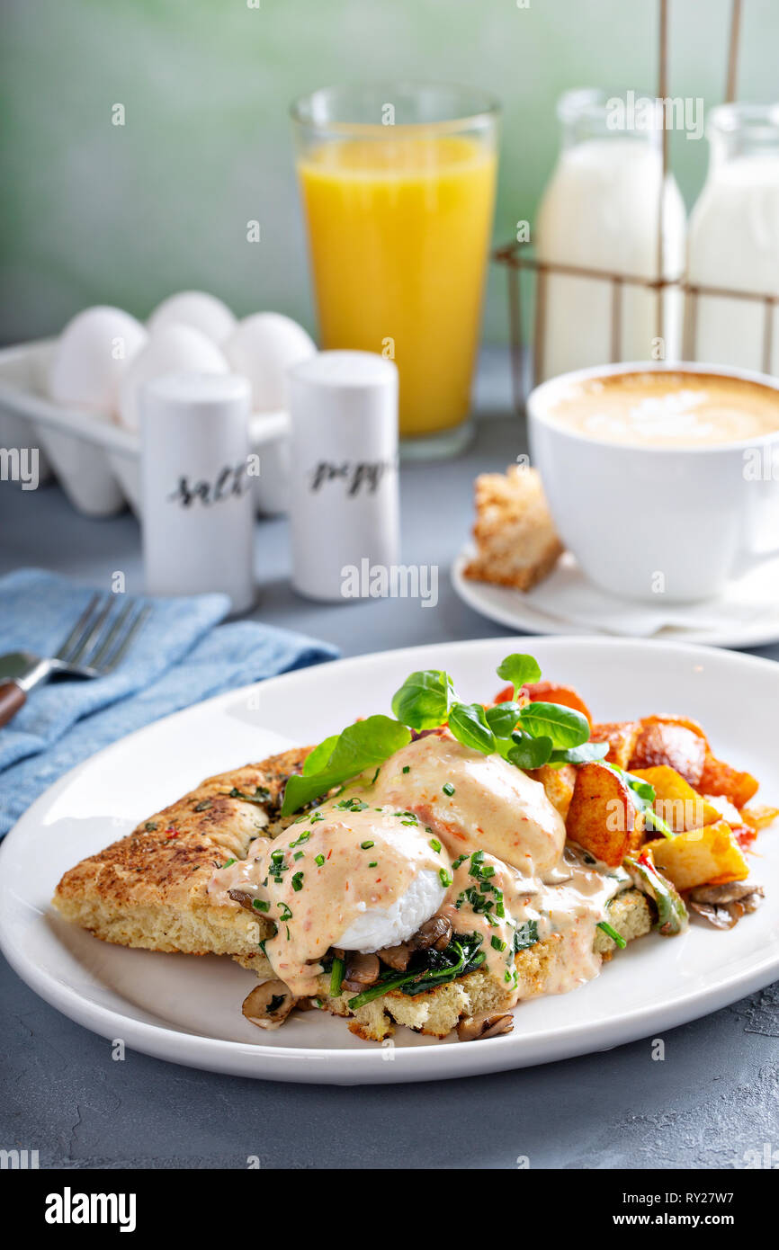 Uova Benedict con focaccia e patate Foto Stock
