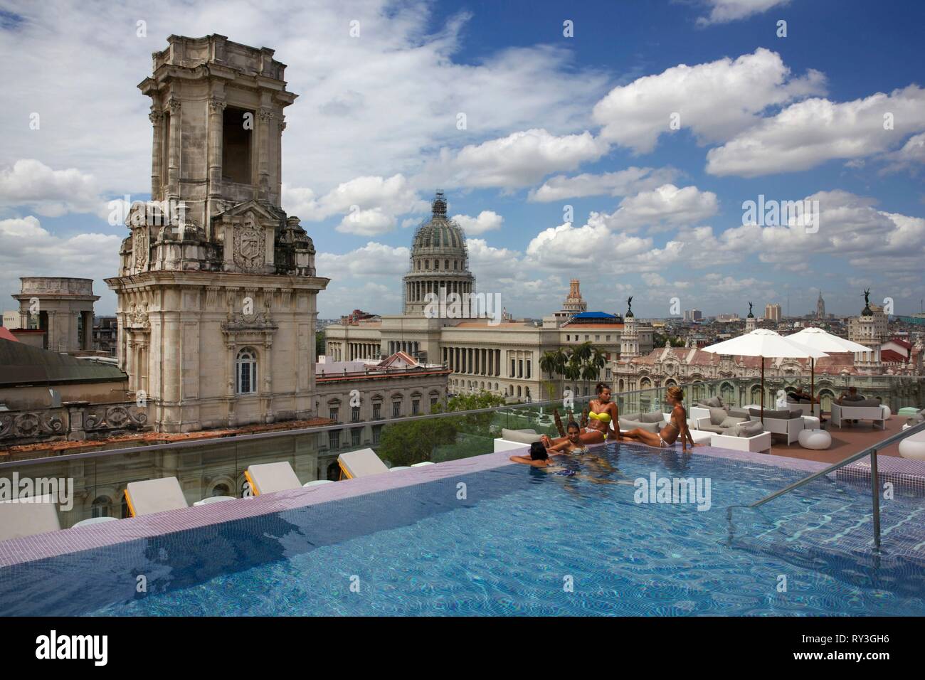 Cuba, La Habana, Havana vecchia, classificato come patrimonio mondiale dall' UNESCO, le donne a bordo della piscina sul tetto del lussuoso Grand hotel Manzana, di fronte al palazzo neoclassico, il Capitole e il Grand Theatre Foto Stock
