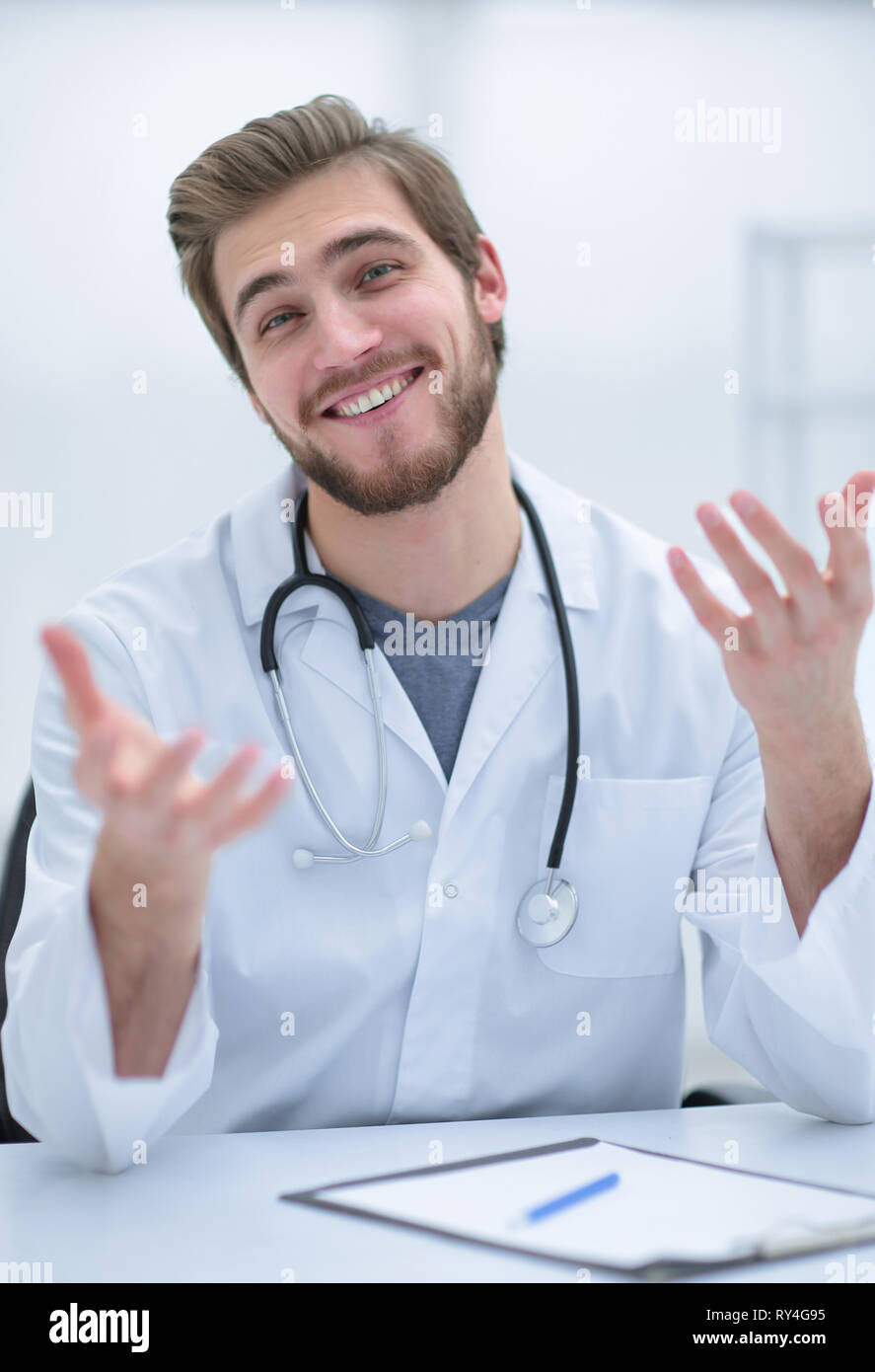 Bello da un medico in camice bianco offre la sua mano Foto Stock