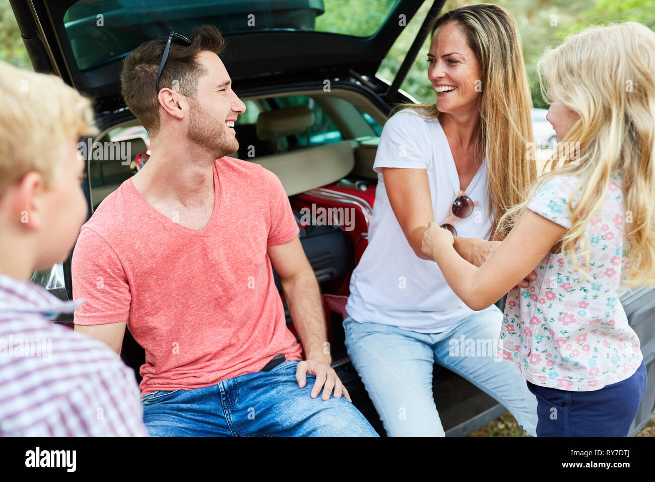 La famiglia felice e due bambini in auto sul viaggio in vacanza estiva Foto Stock