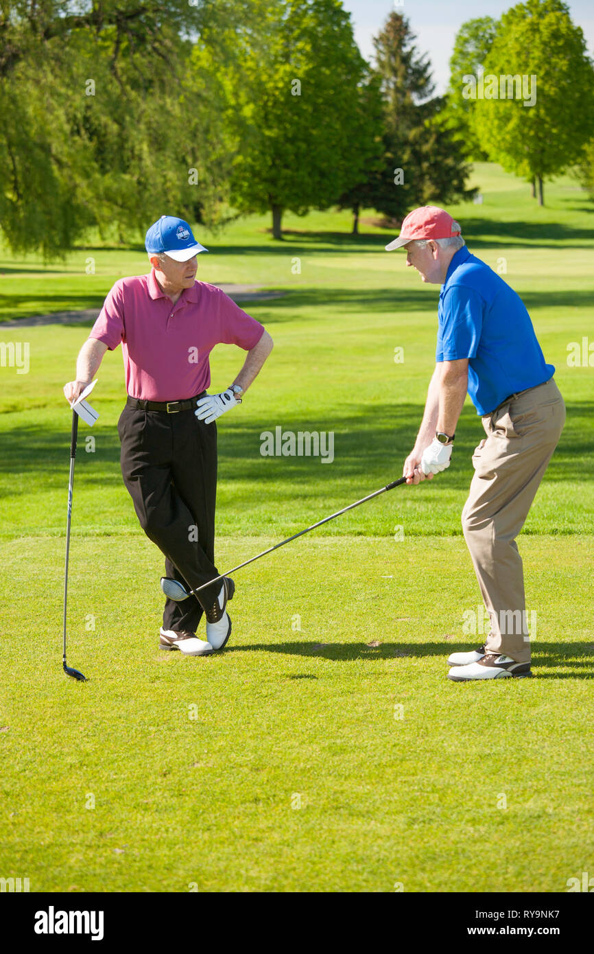 Maschio maturo golfisti discutendo conducente afferrare un corso aGolf, USA USA Foto Stock