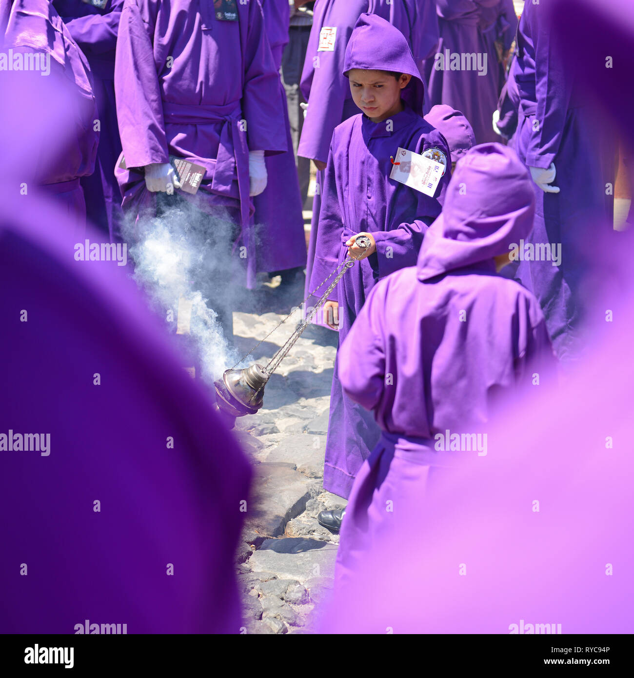 Ragazzo con incenso durante la processione del cucuruchos in Antigua durante la Pasqua il venerdì santo, Guatemala. Foto Stock