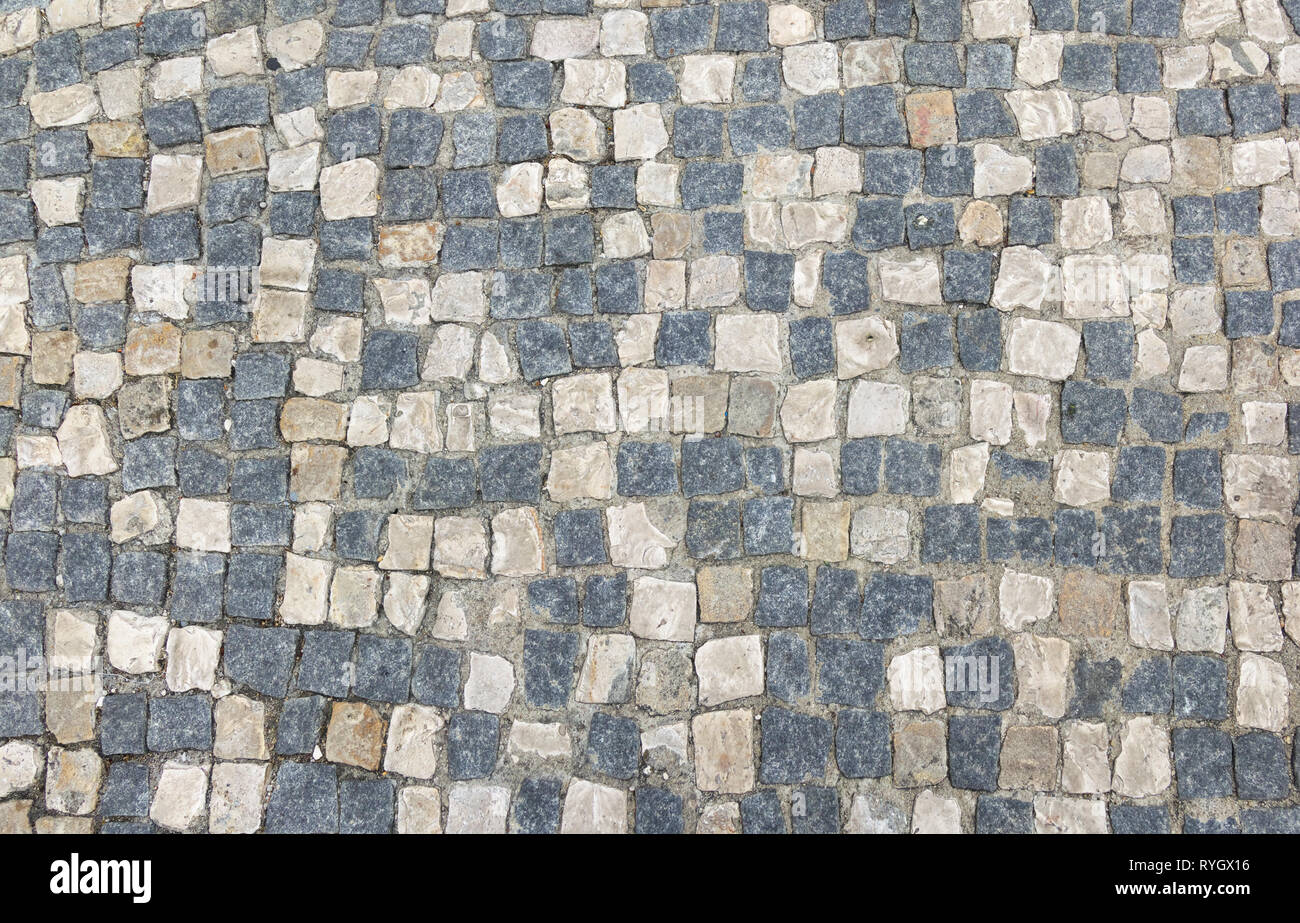 Sfondo astratto di vecchi cobblestone pavement close-up. Foto Stock