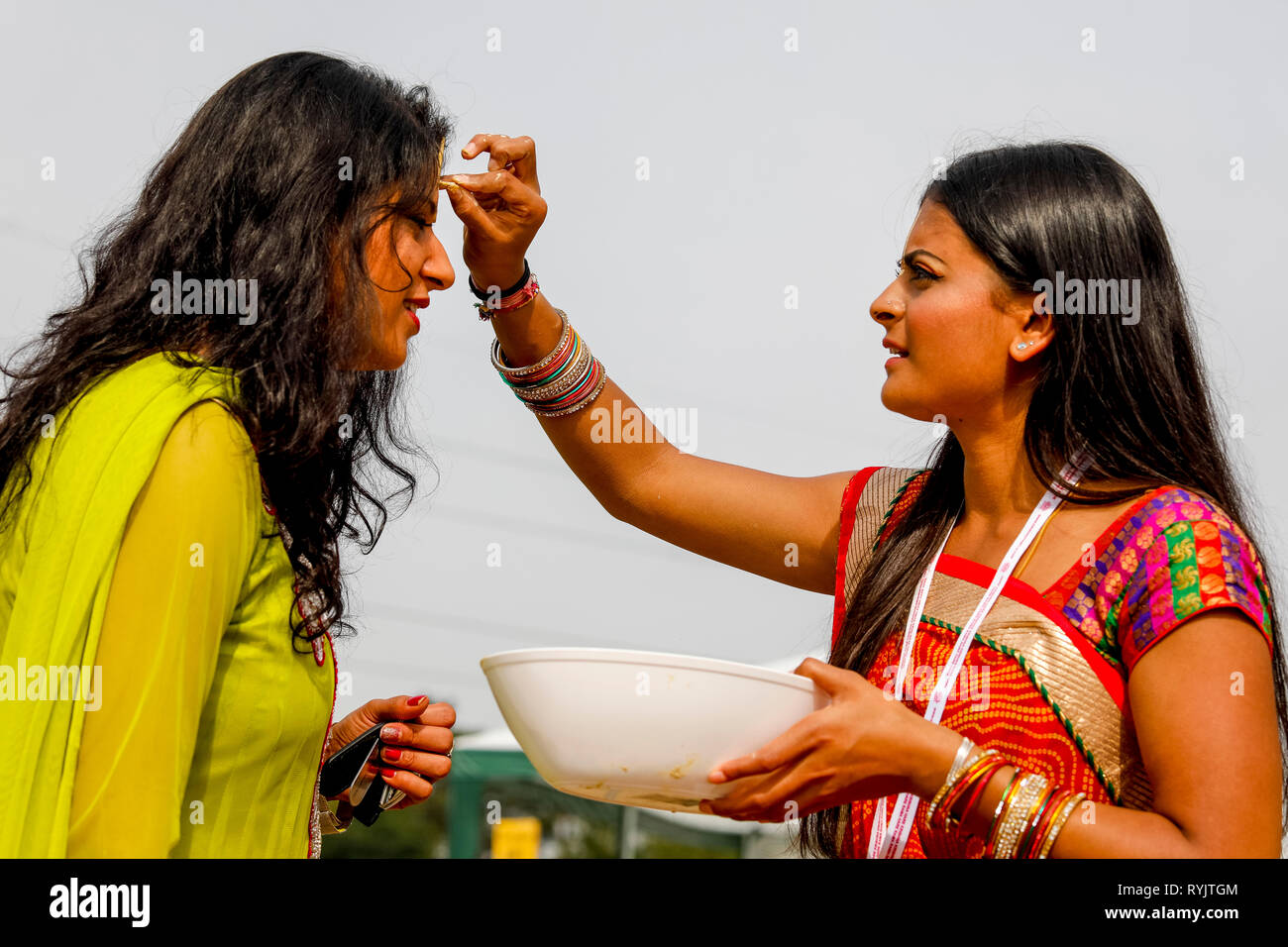 Messaggio di saluto in Janmashtami festival indù, Watford, Regno Unito Gli ospiti ricevono un marchio sulla loro fronte. Foto Stock