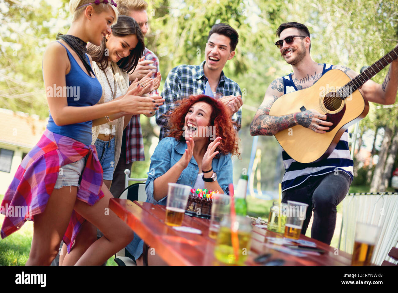 Giovani entusiasti redhead femmina hanno festa a sorpresa per esterno Foto Stock