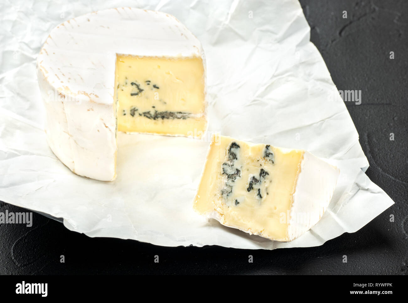 Formaggio Brie con una fetta nell'aprire gli imballaggi di carta di close-up Foto Stock