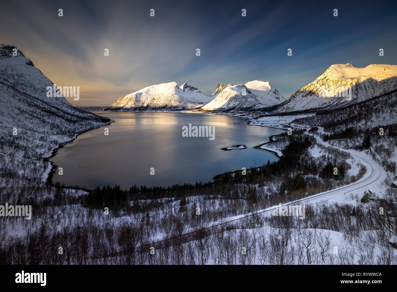 E Bergsfjorden Bergsbotn villaggio tra le montagne innevate, Senja, Norvegia Foto Stock