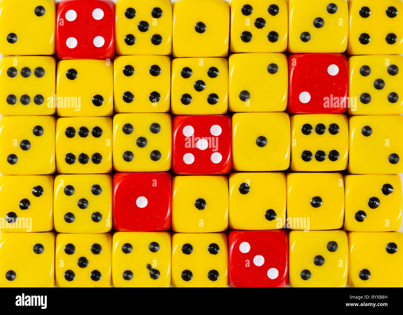 Sullo sfondo di un casuale giallo ordinato plinti con cinque cubi rossi Foto Stock