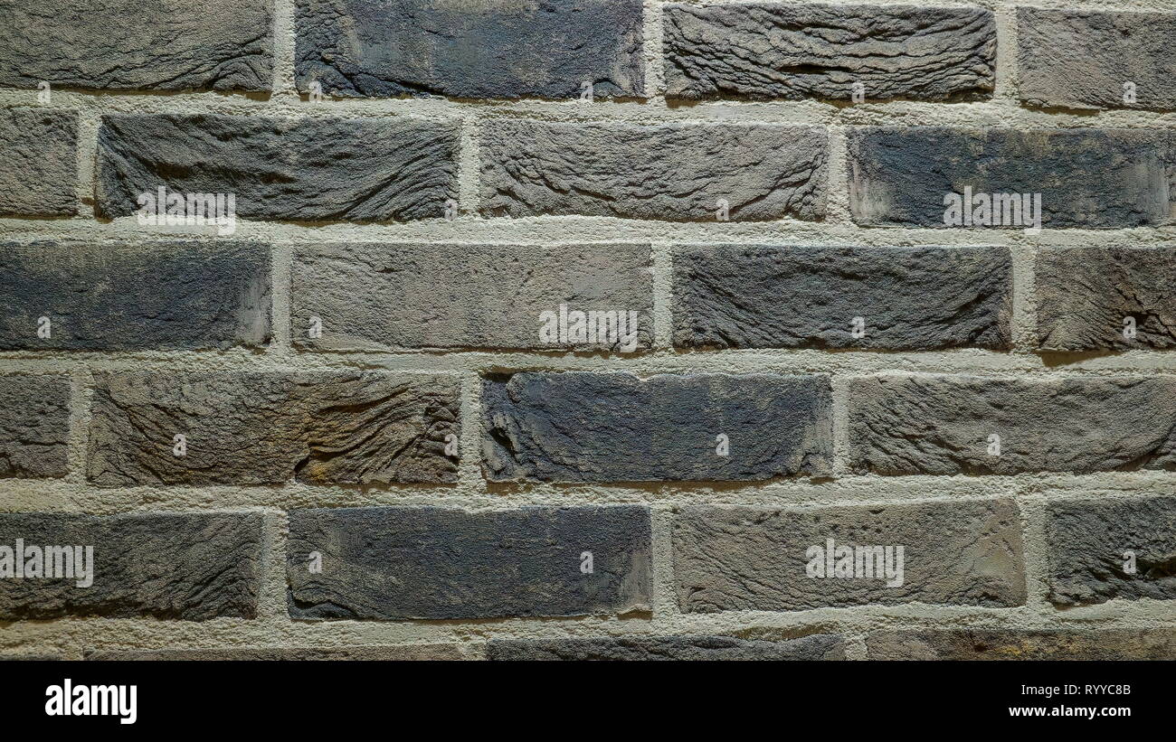 Il colore bianco e grigio mattoni della parete di una casa. Un mattone è la costruzione di materiale utilizzato per realizzare le pareti pavimenti e altri elementi di costruzione in muratura Foto Stock