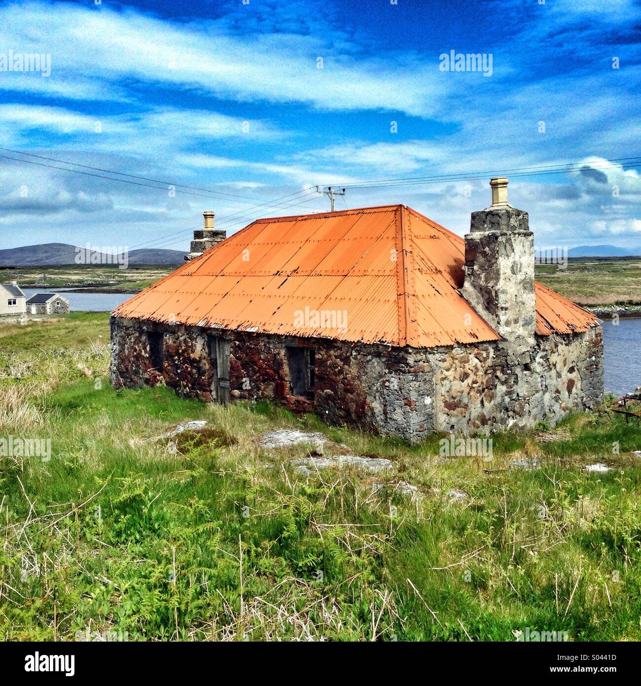Stone casa murata con tetto dello stagno su North Uist nelle Scottish Ebridi Esterne Foto Stock