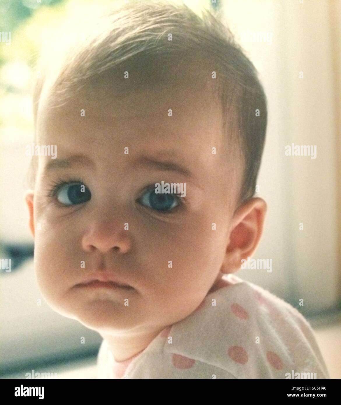 Un close up ritratto di una bambina con la faccia triste Foto Stock