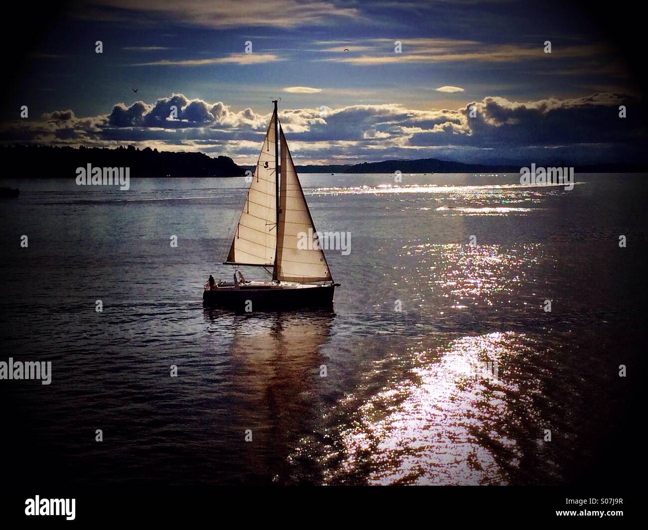 Barca a vela al tramonto Foto Stock