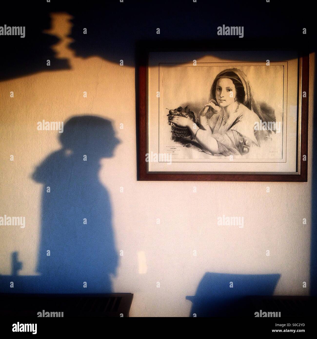 Un ombra di un uomo vicino a un disegno di una donna del Parador Hotel di Arcos de la Frontera, Sierra de Cadice, Andalusia, Spagna - Immagine stock catturata con smartphone