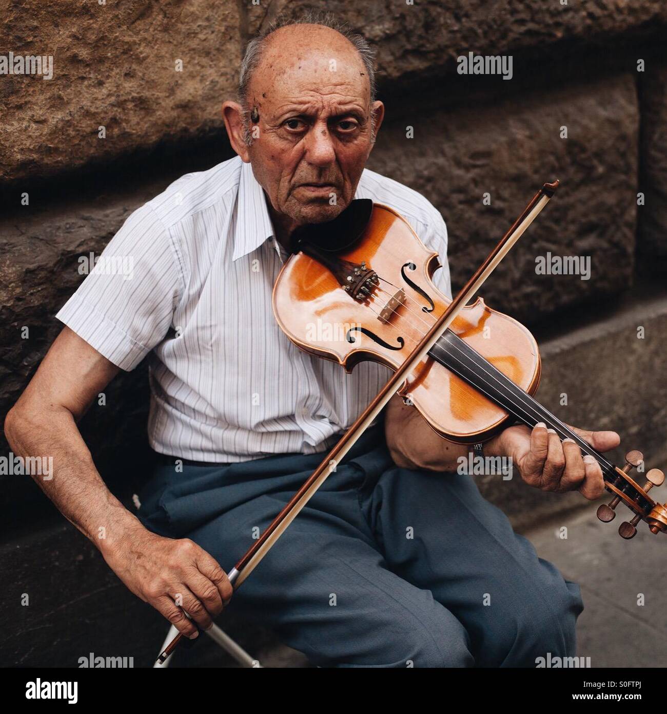 Il vecchio uomo suona il violino sulla strada a Firenze, Italia Foto Stock