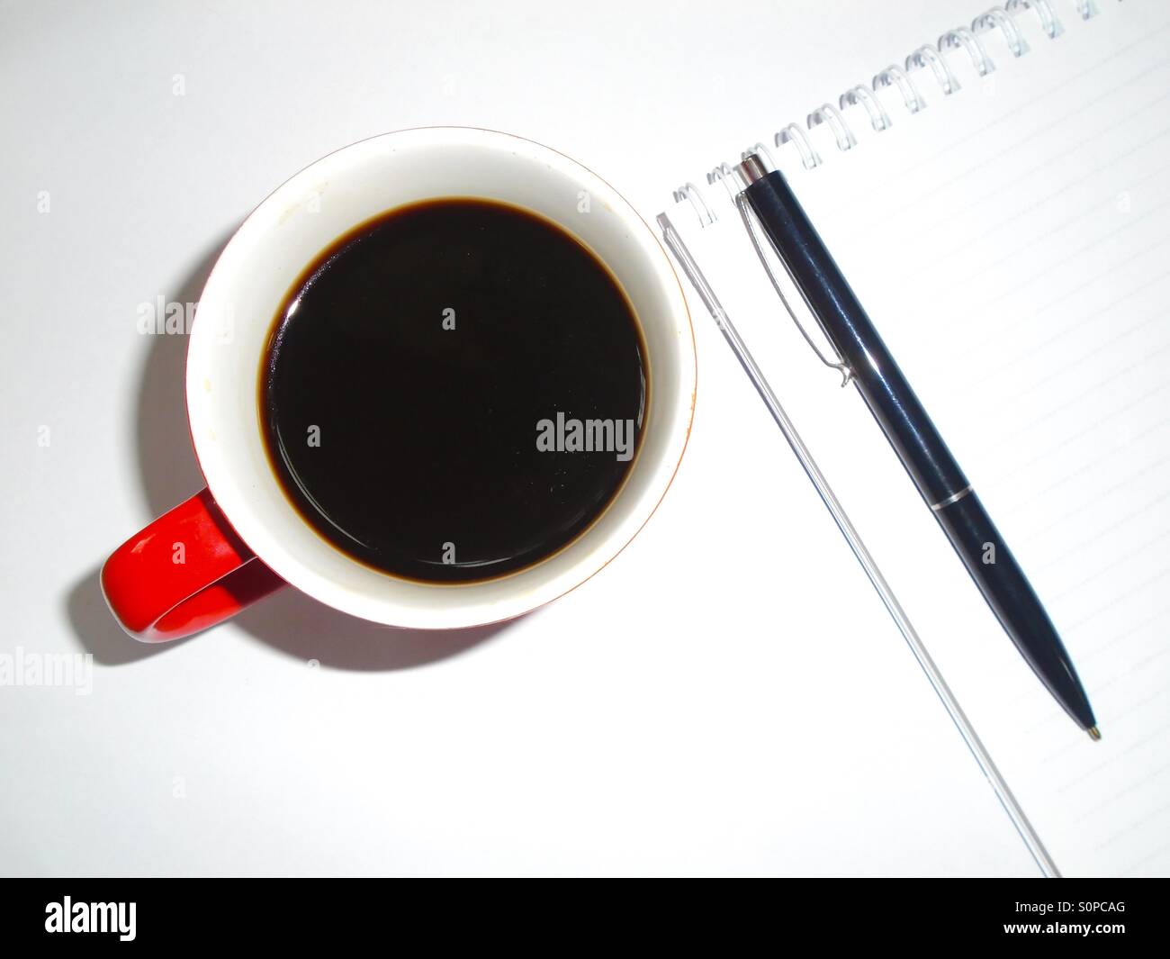 Nero caffè con la penna e il notebook su scrivania Foto Stock