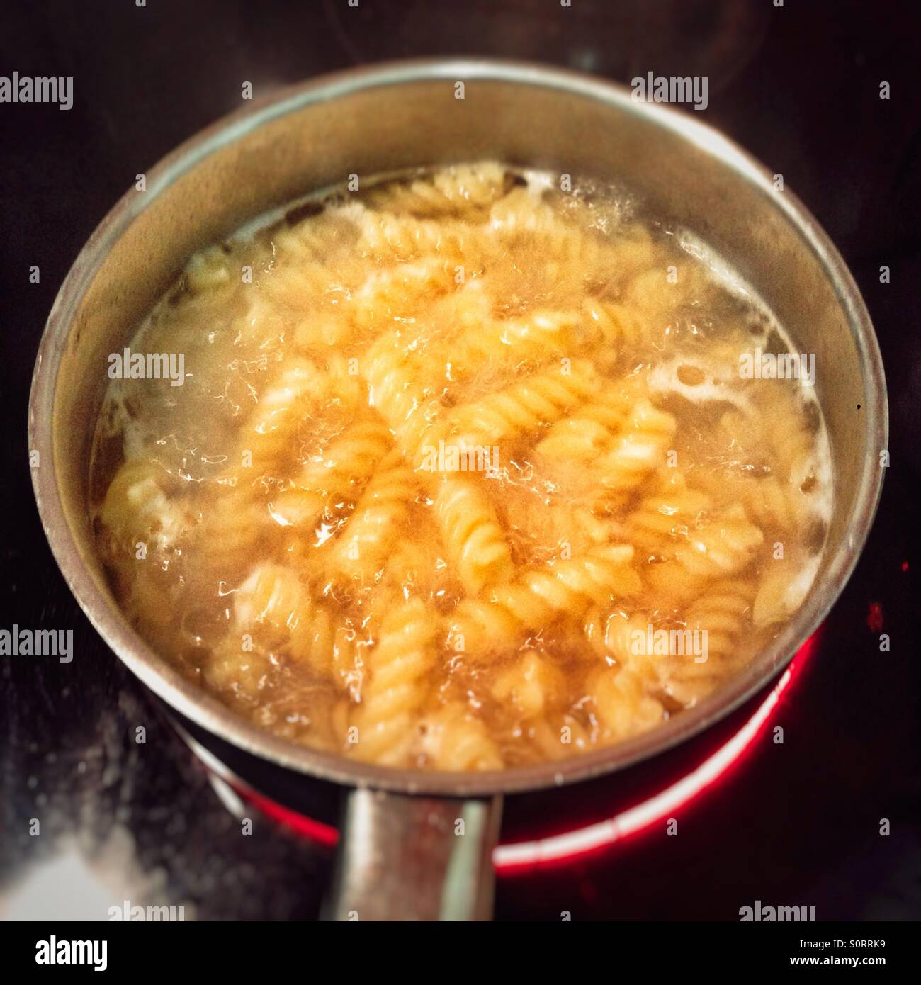Padella di pasta Fusilli cucinata con un lavoro elettrico - Immagine stock catturata con smartphone