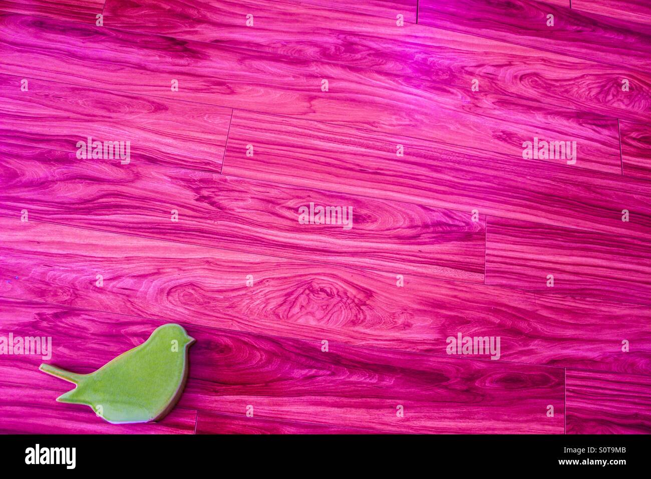 Il minimalismo uccello verde con sfondo rosa copia lo spazio negativo Foto Stock