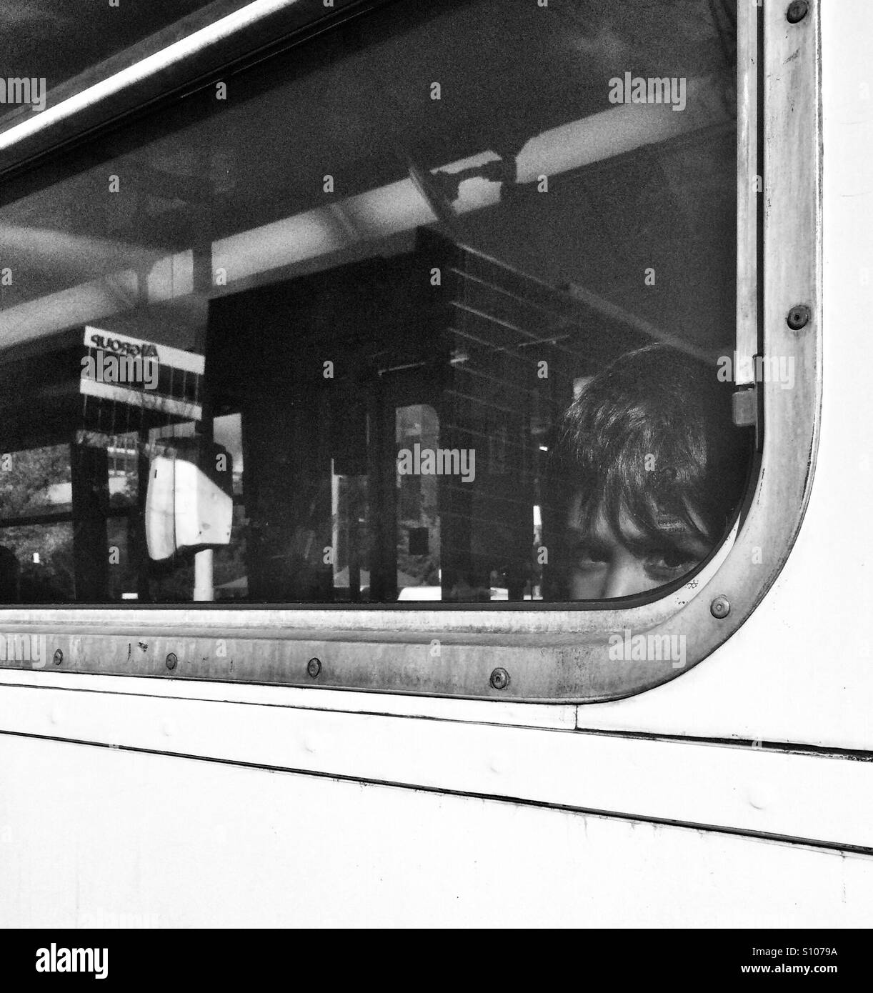 Un giovane ragazzo con la faccia premuta contro una finestra del tram a Melbourne, Australia Foto Stock