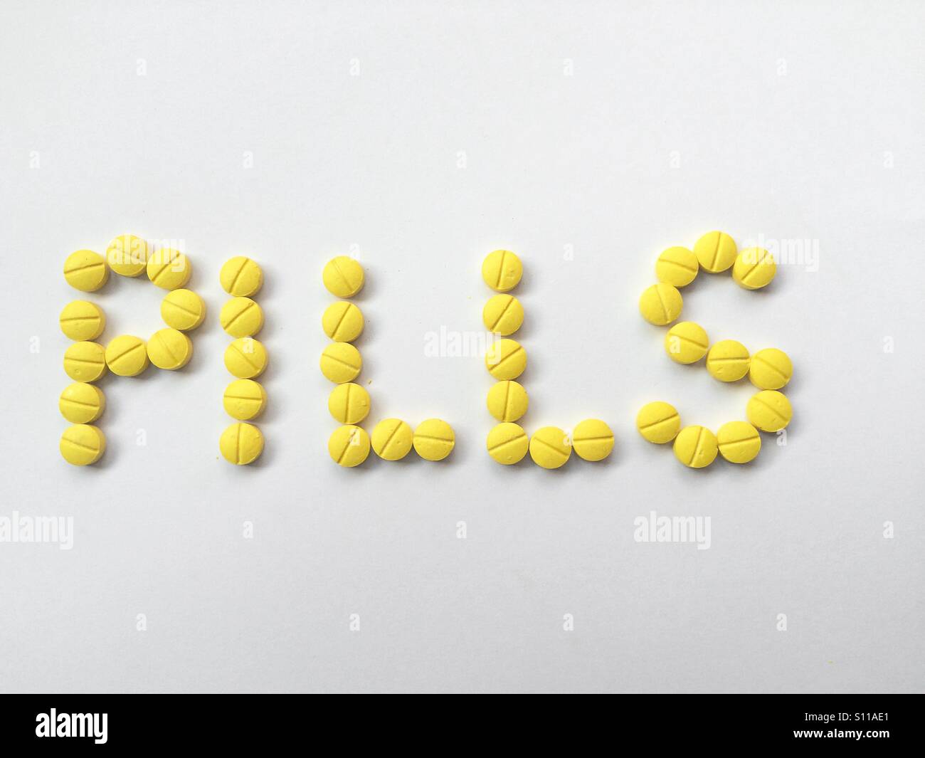 Le pillole di parola scritta con le pillole di giallo - Immagine stock catturata con smartphone