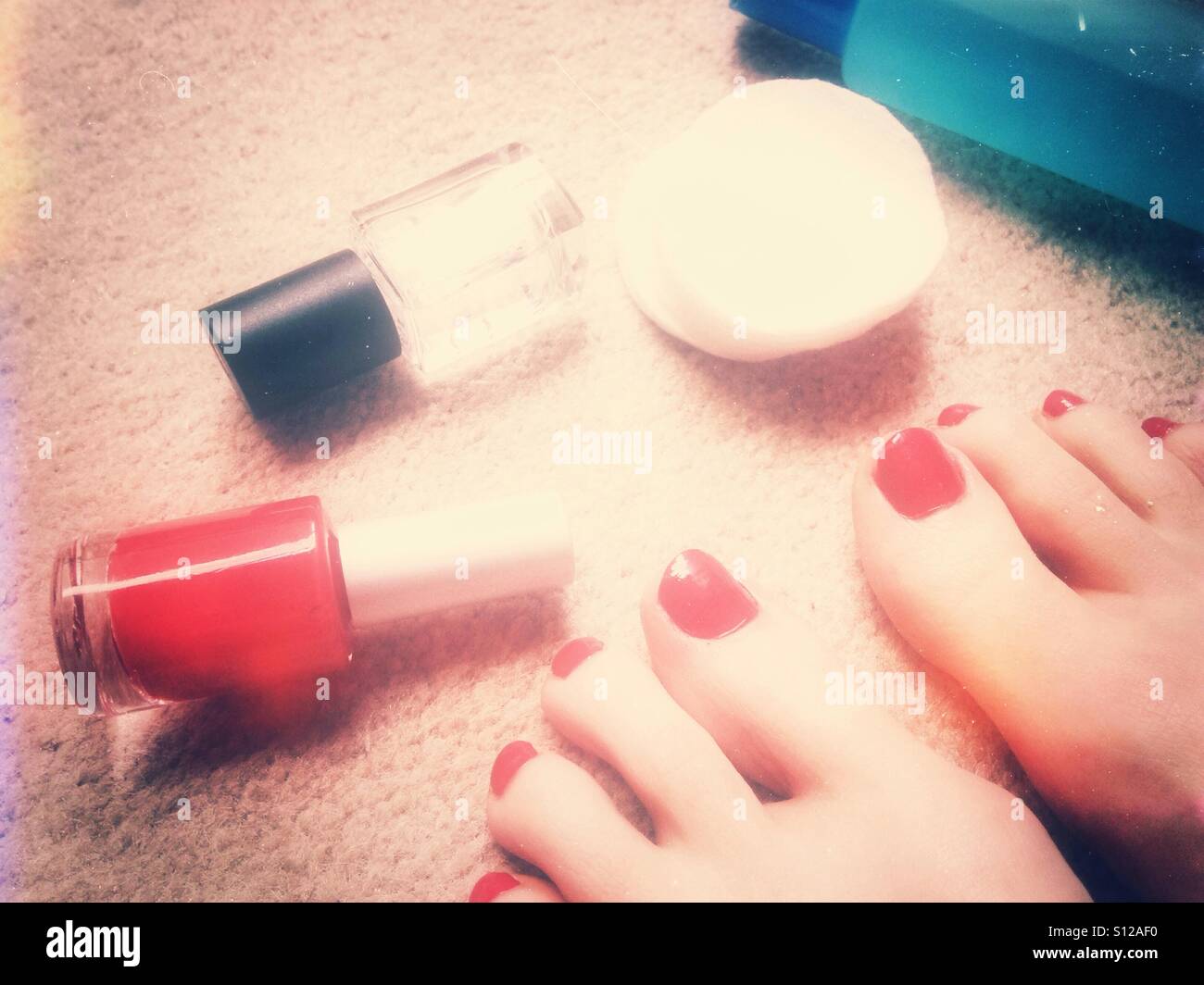 Red pedicure e smalti per unghie su un tappeto Foto Stock