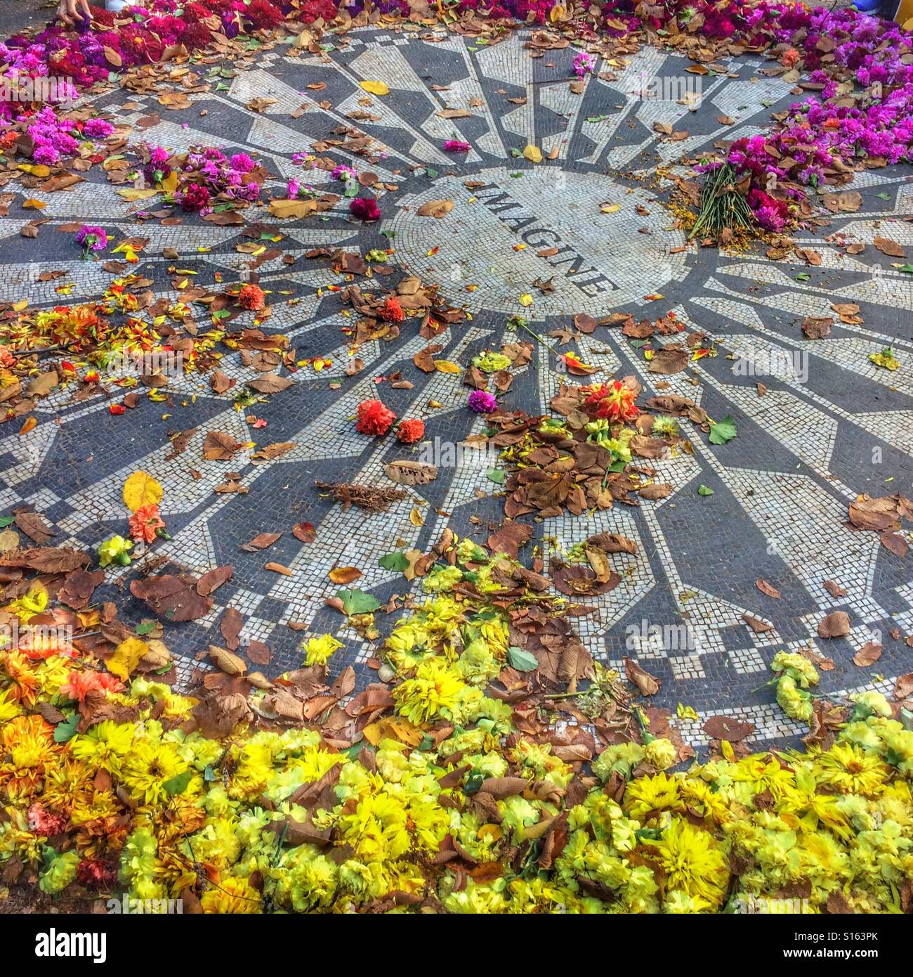 John Lennon memorial mosaico ricoperti di fiori, Strawberry Fields, al Central Park di New York City, Stati Uniti d'America. Foto Stock