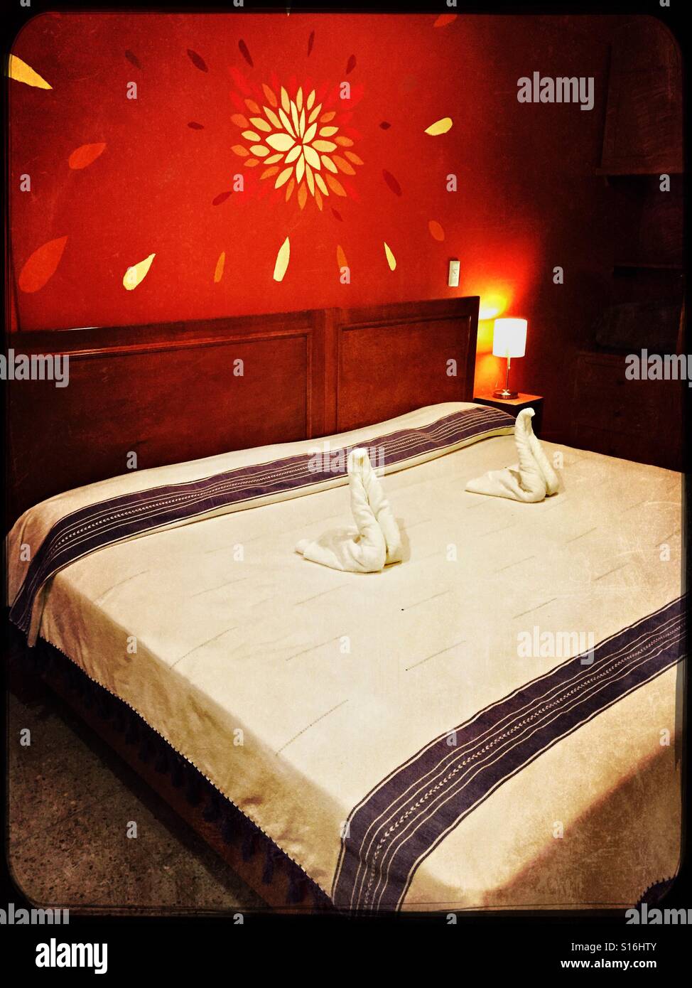 Asciugamano arte cigni sul letto aggiunto un ulteriore tocco di bellezza e fantasia per questo coloratissimo, pulito e accogliente camera presso l'Hotel Florida a Oaxaca, Messico. Foto Stock