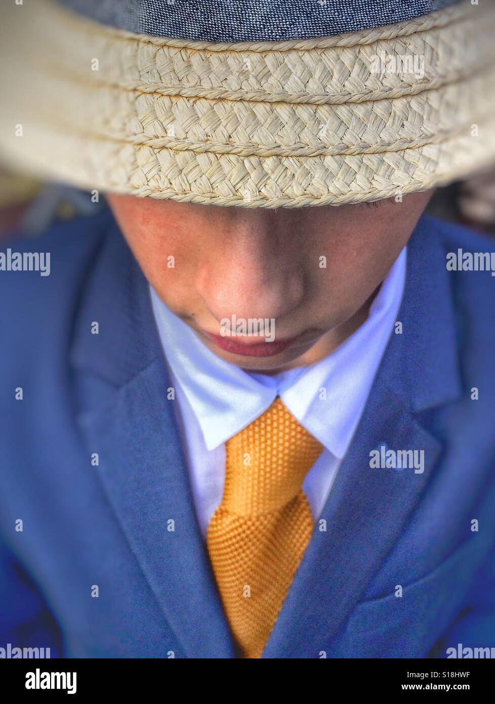 Un giovane ragazzo che indossa un cappello, giacca e cravatta Foto Stock