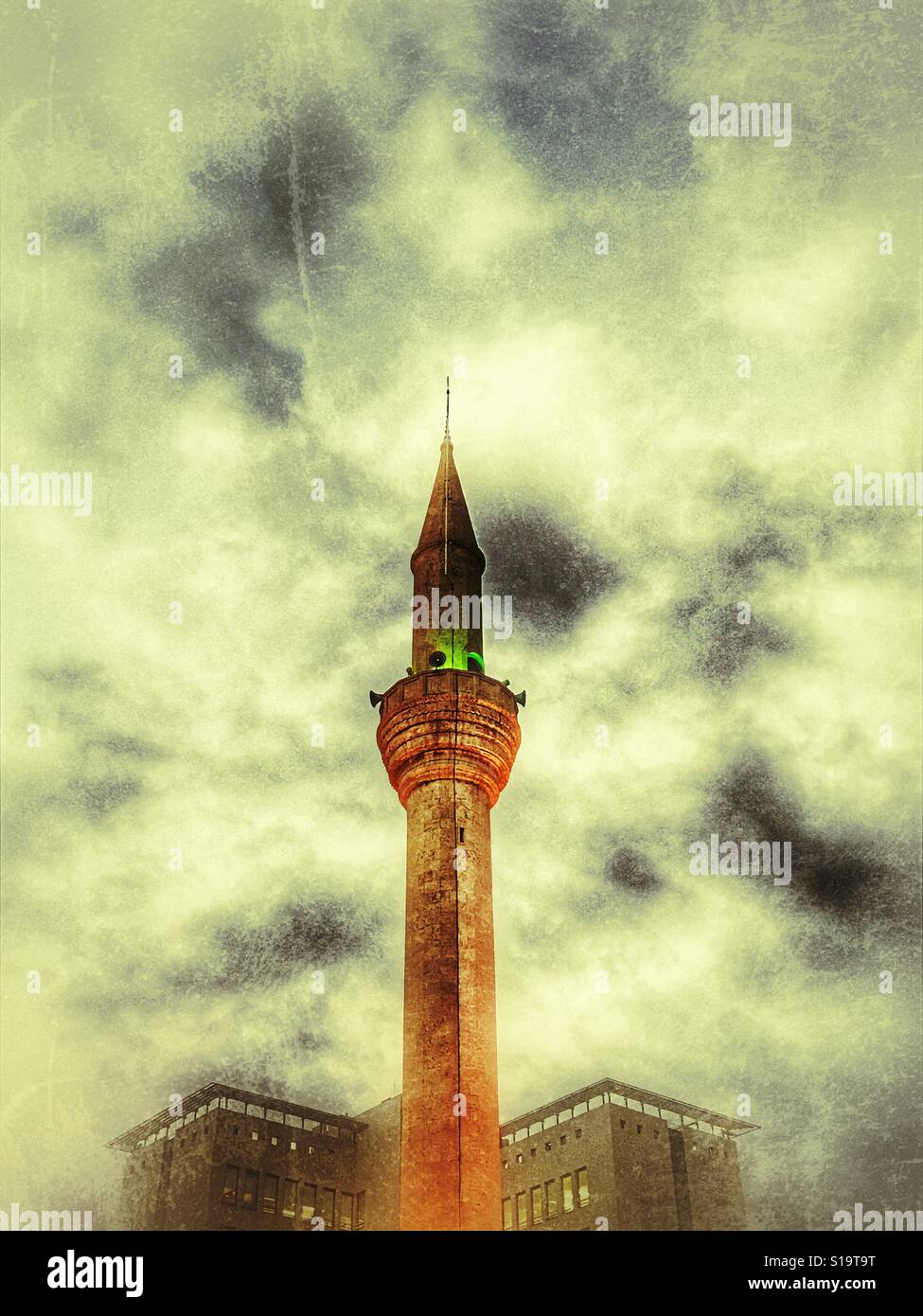 Minareto della moschea con edifici dietro di essa - Immagine stock catturata con smartphone