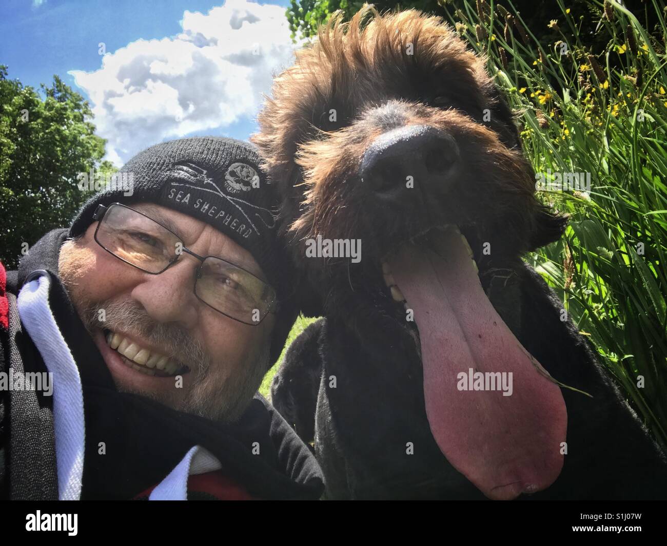 L'uomo prendendo un selfie con il suo cane Foto Stock