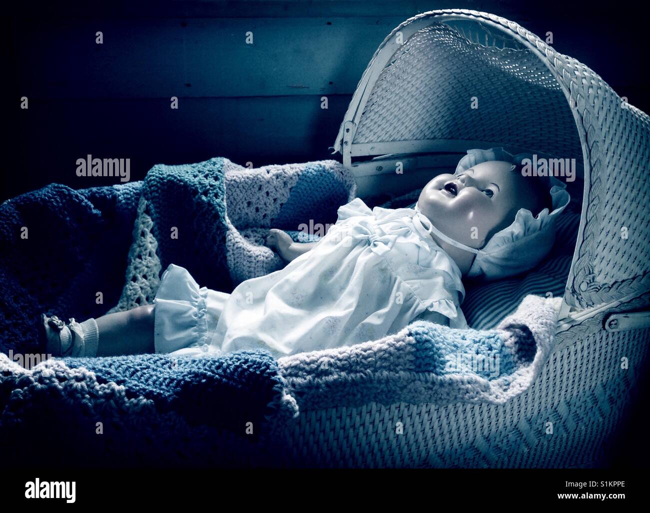 Nap tempo- indossando un cofano increspato e vestito, Doris la composizione bambola è giù per nap in culla vintage Foto Stock