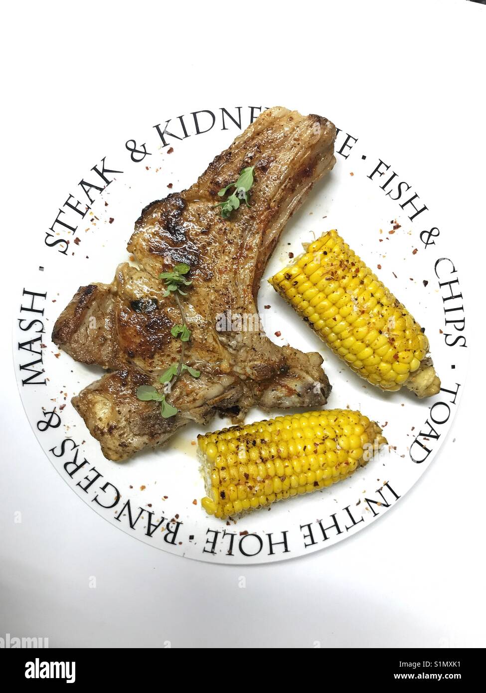 In casa bistecca con sulla pannocchia di mais su una piastra - Immagine stock catturata con smartphone