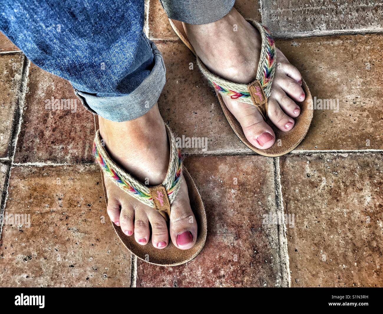 Donna in piedi da flipflops Fatface, ad alto angolo di visione Foto Stock