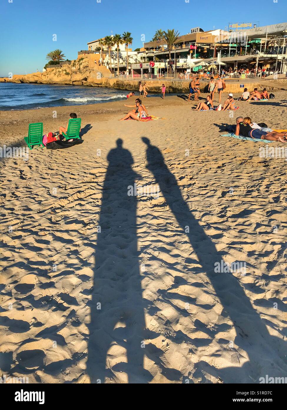 Di sera tardi e lunghe ombre sulla spiaggia di Arenal, Javea Alicante, Spagna Foto Stock