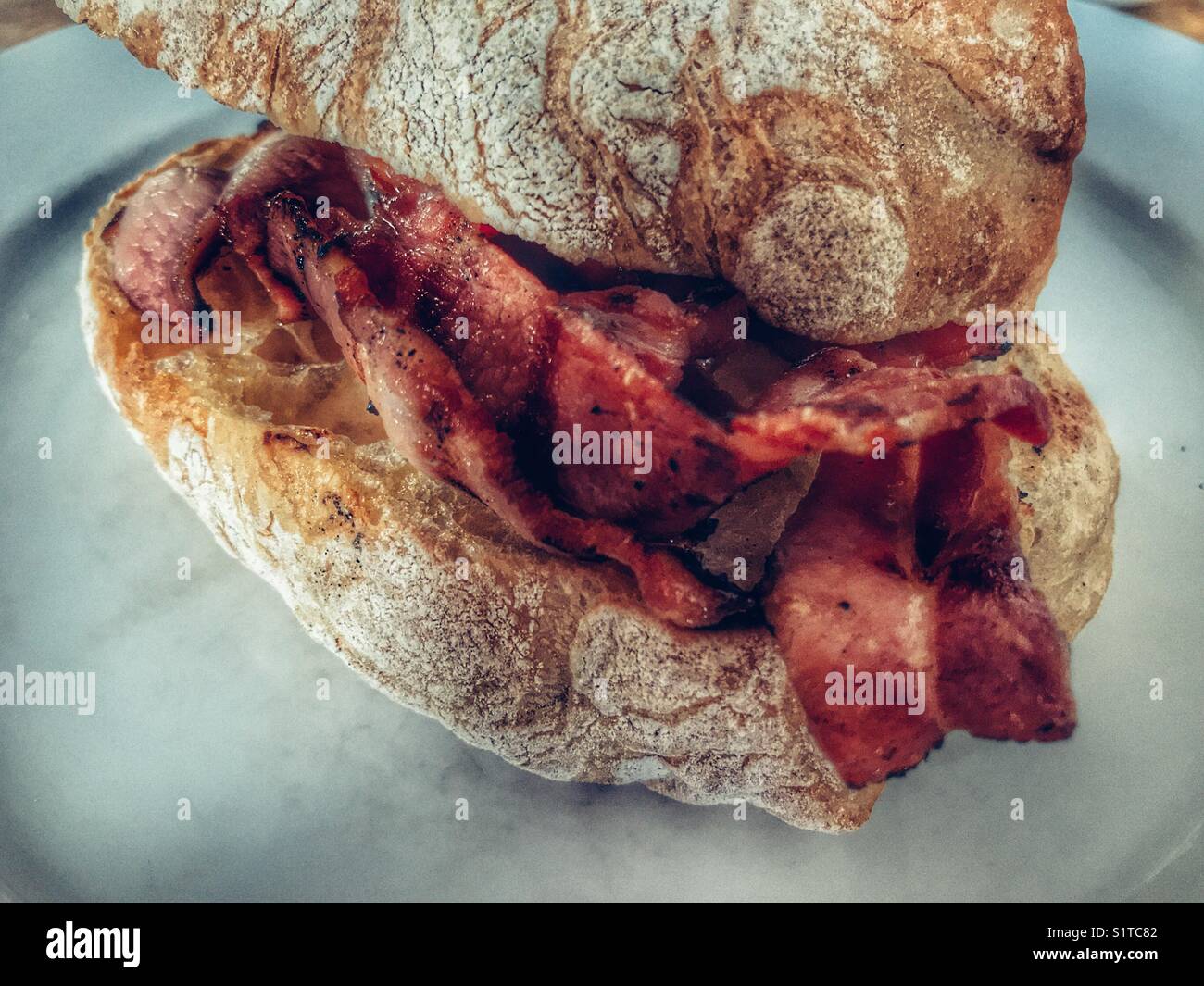 Bacon butty su una piastra Foto Stock