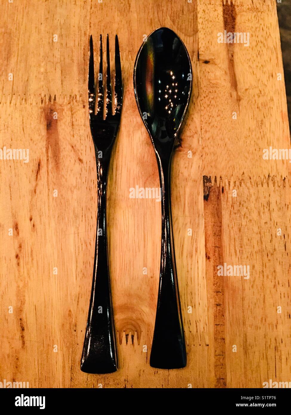 Forcella di nero e il cucchiaio sul tavolo di legno Foto Stock