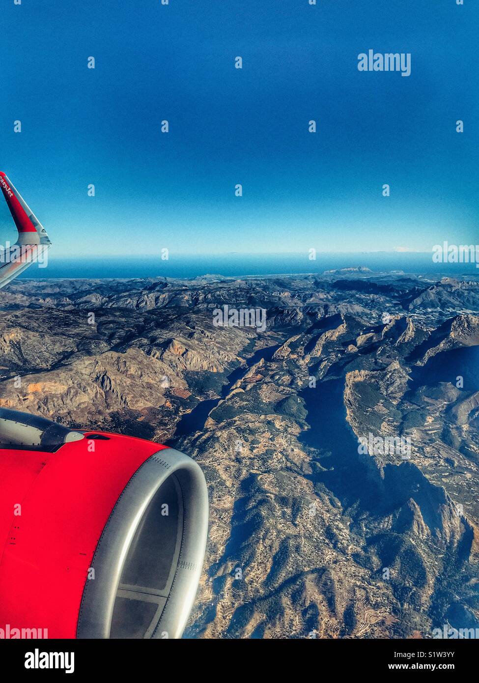 Vista dall'aereo EasyJet con punta ala e motore, guardando la costa mediterranea della Spagna con la località di Javea e Monte Montgo sulla Costa Blanca visibile Foto Stock
