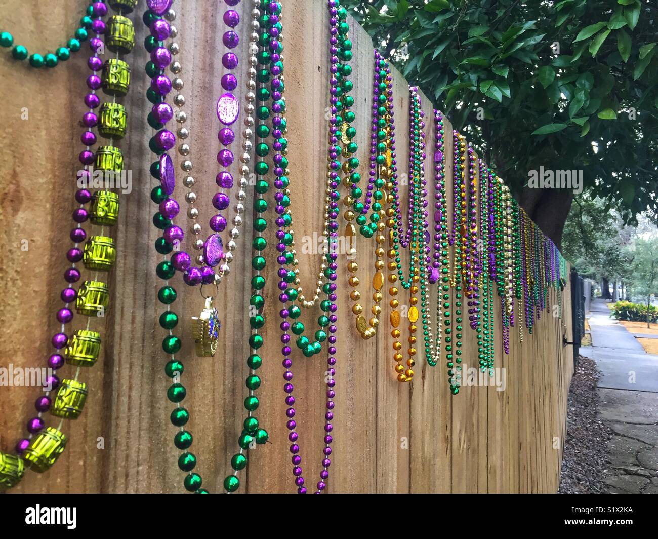 Mardi Gras beads sulla recinzione in New Orleans Foto Stock