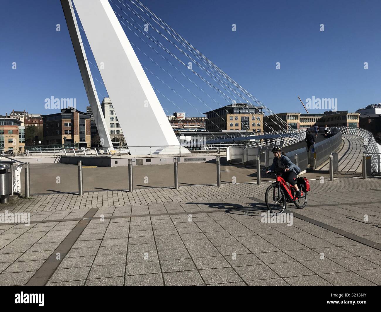 Bicicletta elettrica essendo cavalcato sul Millennium Bridge, Newcastle-Gateshead Foto Stock