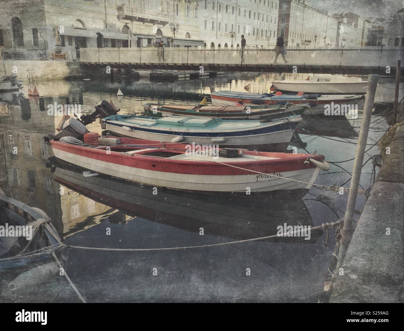 Barche ormeggiate sul Canal Grande con una passerella pedonale Passaggio Joyce in background - Trieste, Friuli Venezia Giulia, Italia Foto Stock