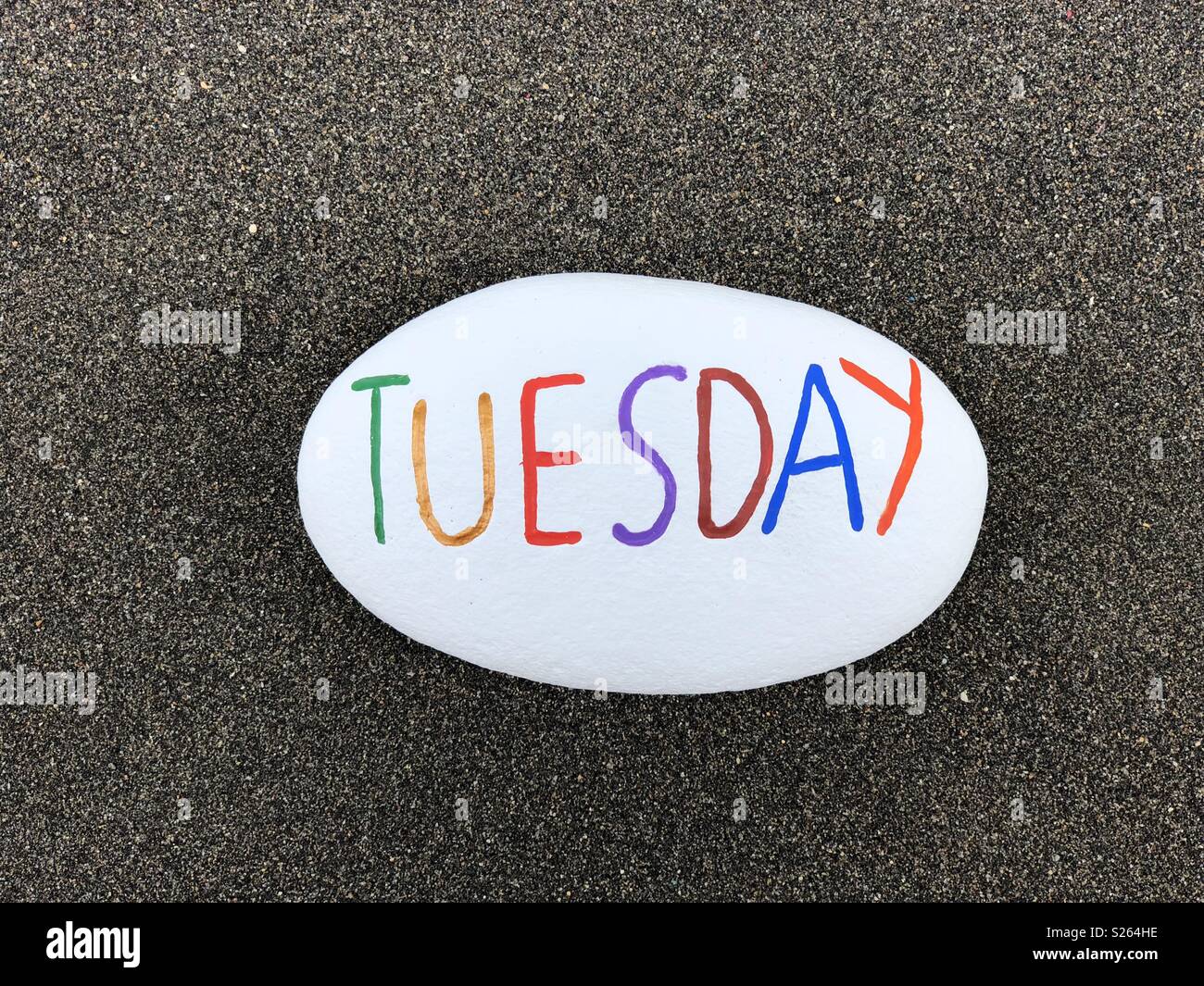Martedì, secondo giorno della settimana scolpita e dipinta su una pietra sopra sabbia vulcanica Foto Stock