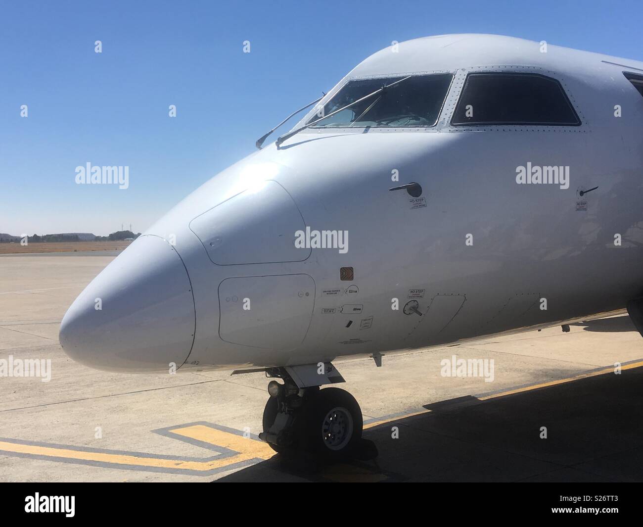 Il naso e la cabina di pilotaggio di un sudafricano Express De Havilland DHC8-400 aerei di serie su asfalto a Bram Fischer International Airport, Bloemfontein, Sud Africa. In primavera. Foto Stock