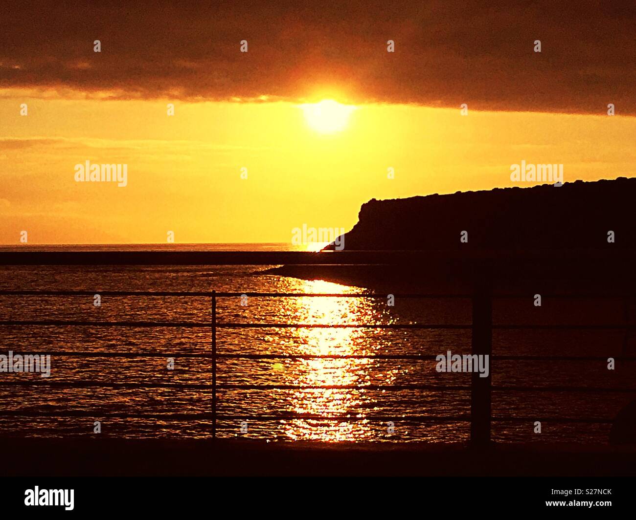 Sun impostazione sotto bassa nuvola sul mare a La Caleta, Tenerife - Immagine stock catturata con smartphone