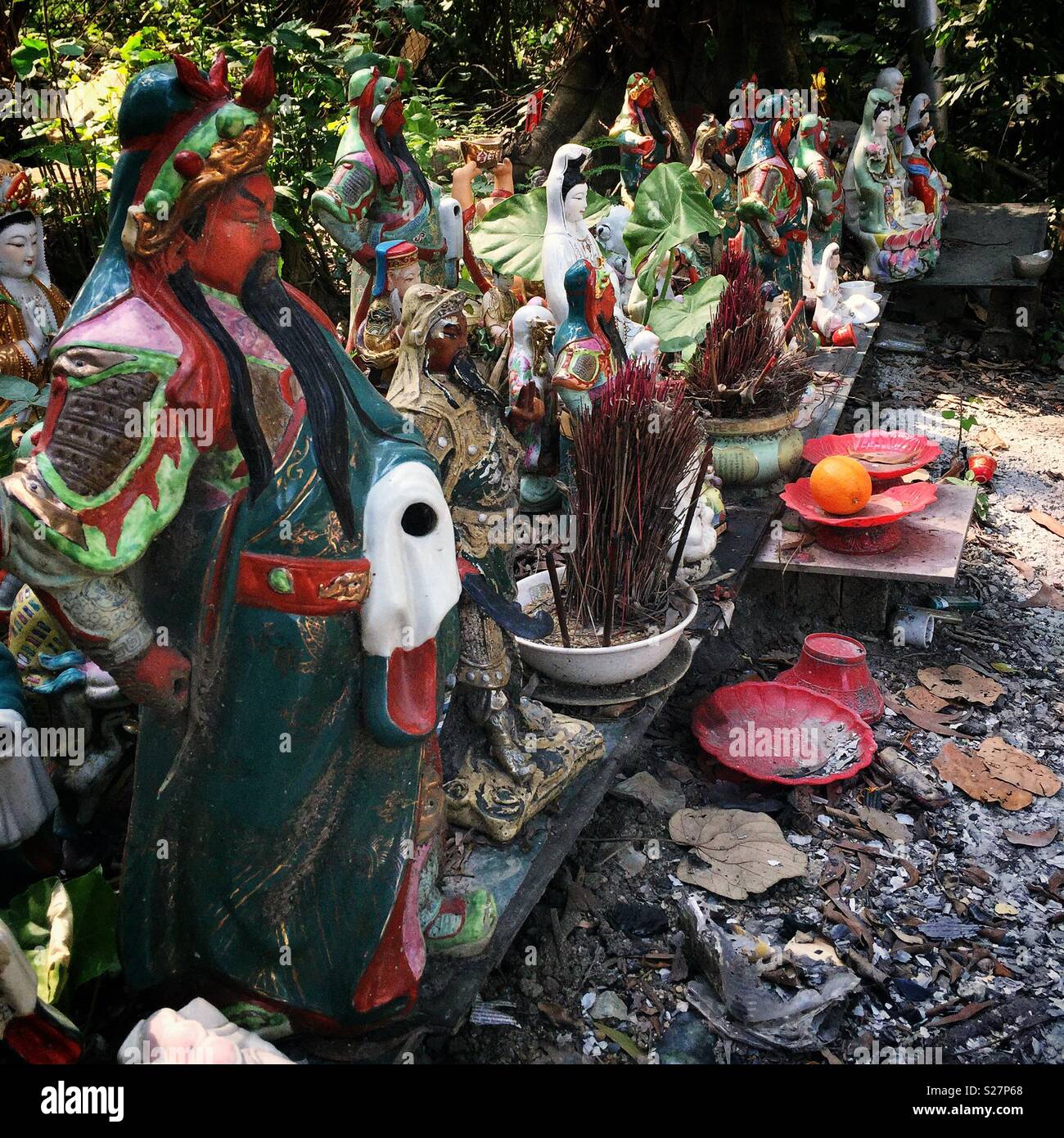 Le effigi di Guan Yu, Tin Hau e altri cinesi dèi domestici in corrispondenza di un bordo strada altare in Nuovi Territori di Hong Kong Foto Stock