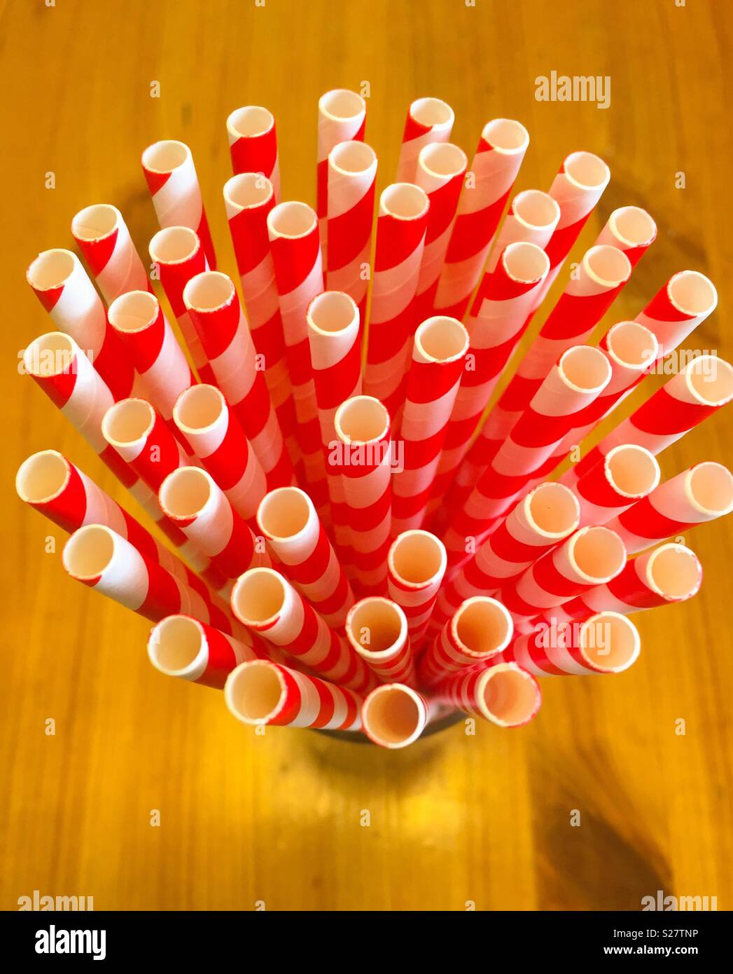 Bicchiere pieno di rosso e bianco cannucce di carta Foto Stock