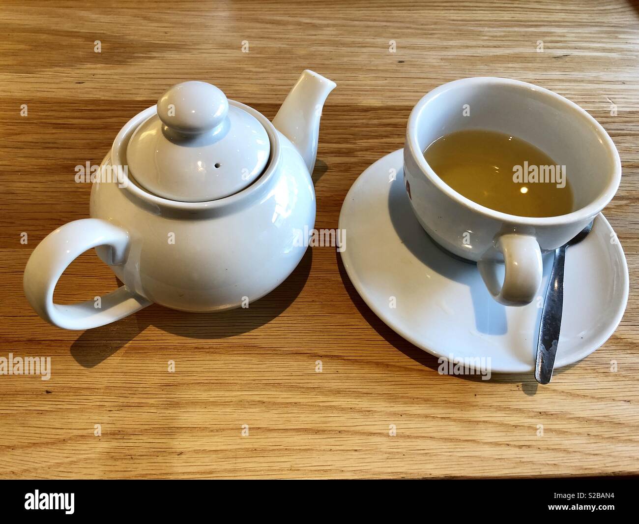 White tazza di tè verde e un individuo, bianco teiera Foto Stock
