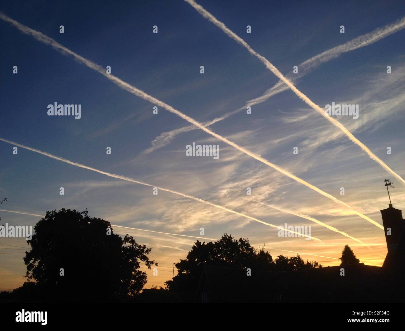 La mattina presto rush hour nei cieli sopra Sussex, Inghilterra. Aeroplano contrails in tutte le corsie. Foto Stock