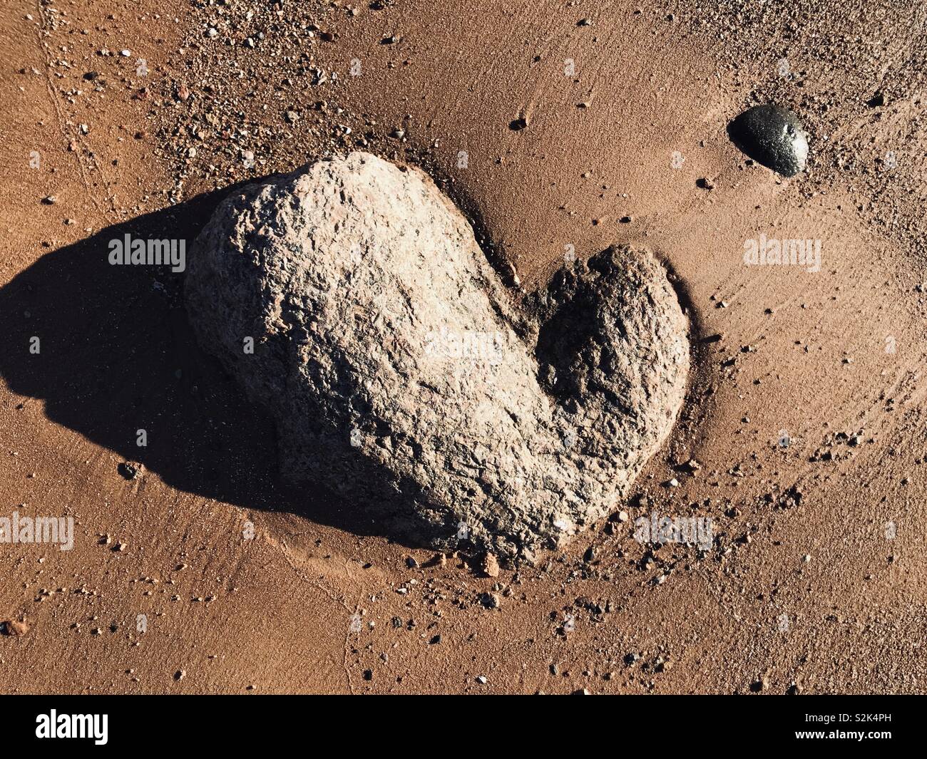 Cuore di pietra sulla spiaggia. Sunny trovare al mare del Baltico. Foto Stock