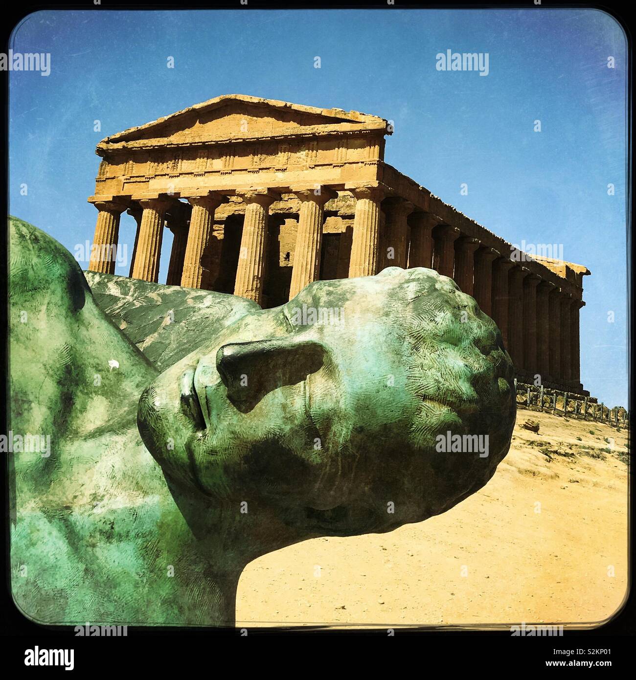 Tempio essendo photobombed da Mitoraj scultura in bronzo. Valle dei Templi, Agrigento, Sicilia Foto Stock