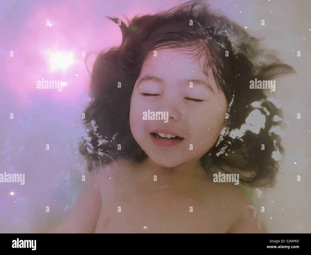Giovani e carine multi-etnico (vietnamita/Caucasian/Punjabi) ragazza sognare l'universo. Foto Stock